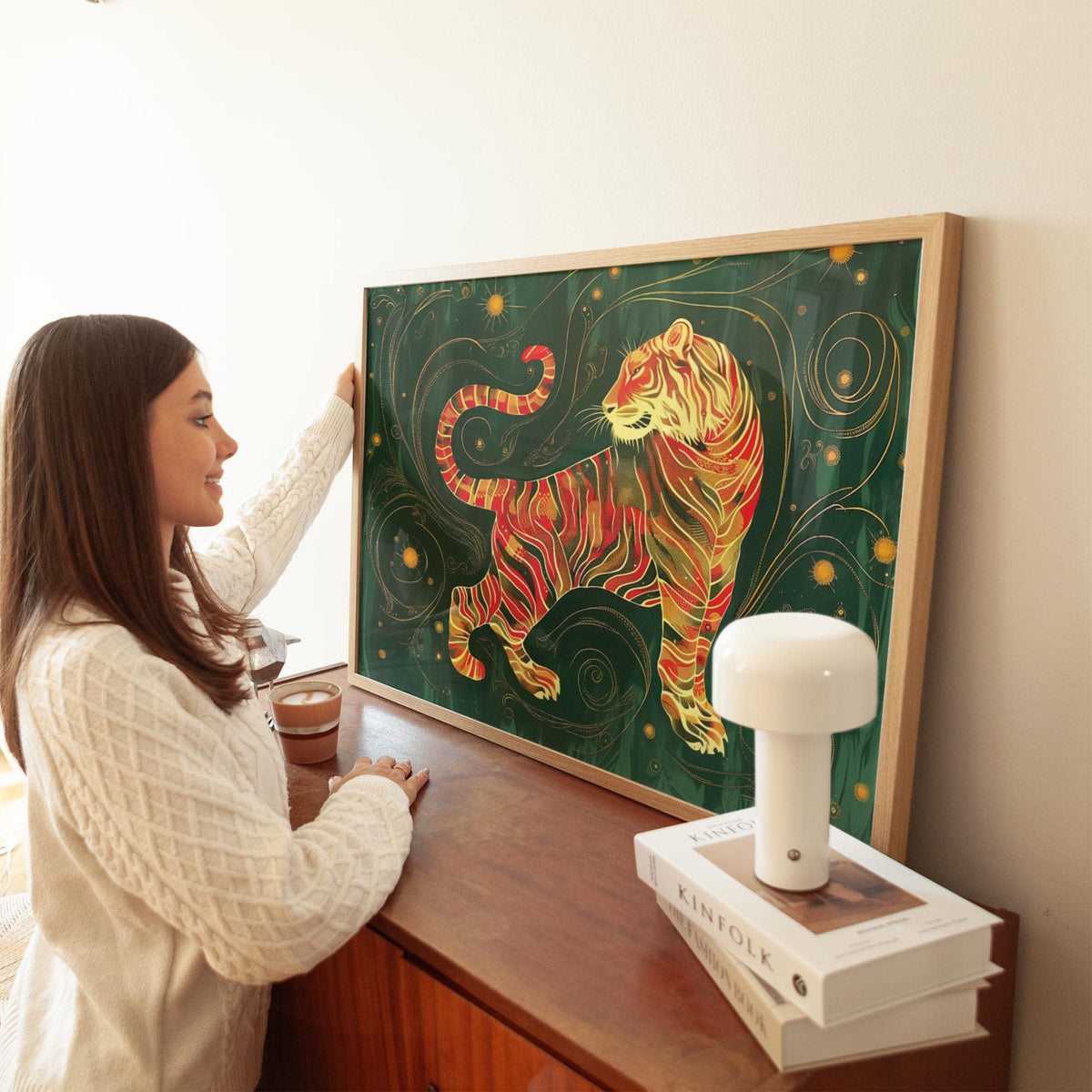 Framed Oriental wall art showing a golden tiger with red stripes leaning on a wooden cabinet with lamp
