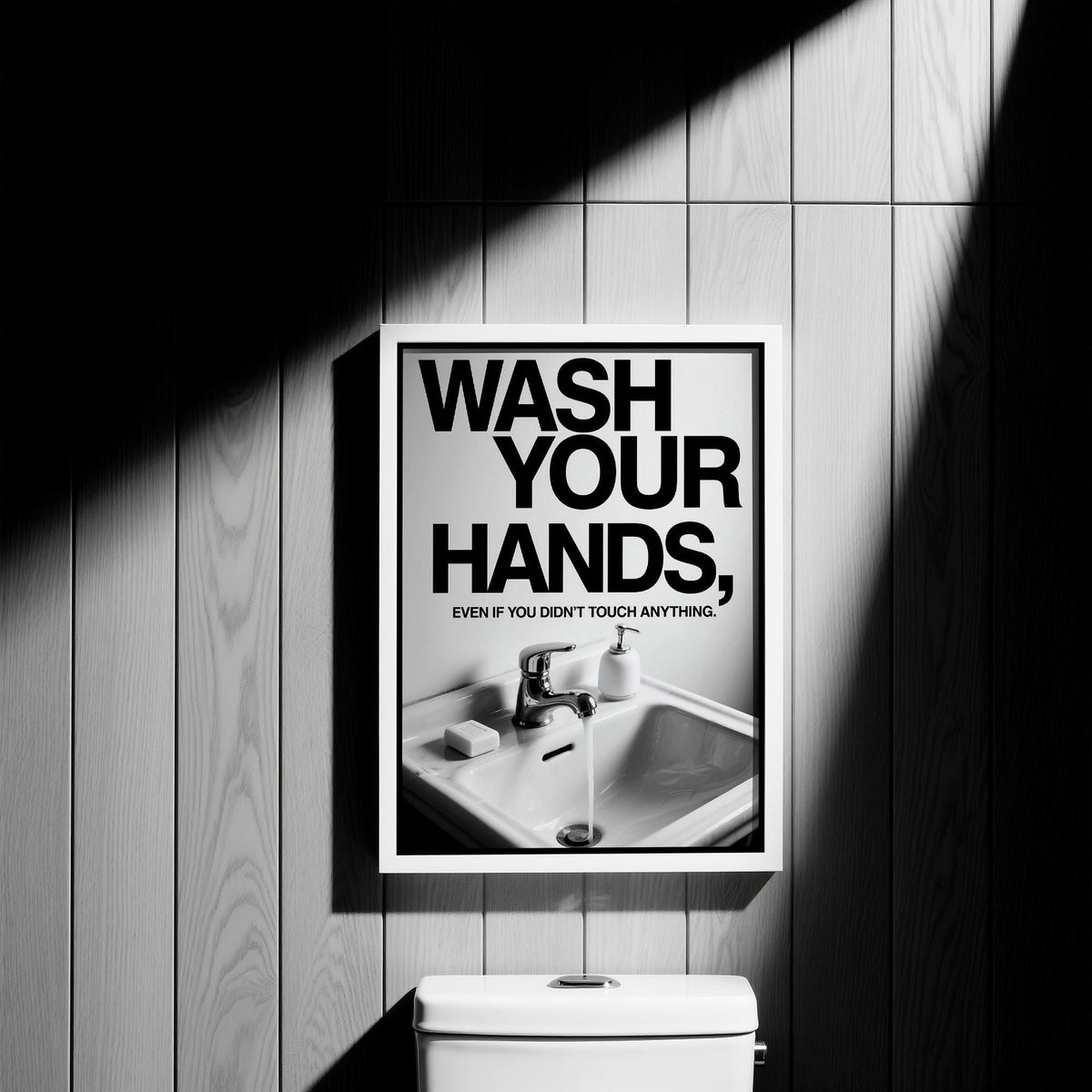 Framed Toilet Wall Art Funny with black text and sink image in graphic black and white style on wood wall above toilet