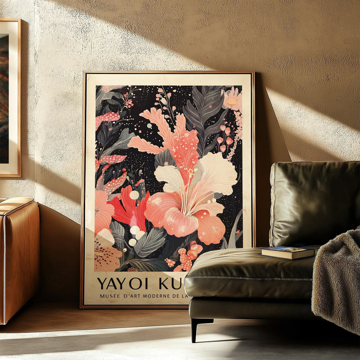 Black and Pink Wall Art leaning on floor beside a green leather armchair in a sunlit living room