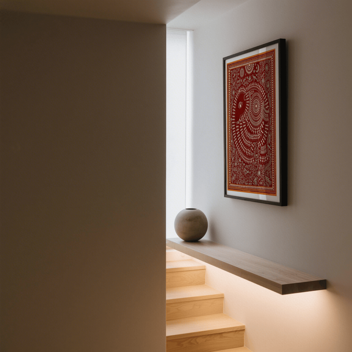 Print of Indian Folk Art Poster with a decorative elephant in red and cream on a hallway wall above a floating shelf with a round vase