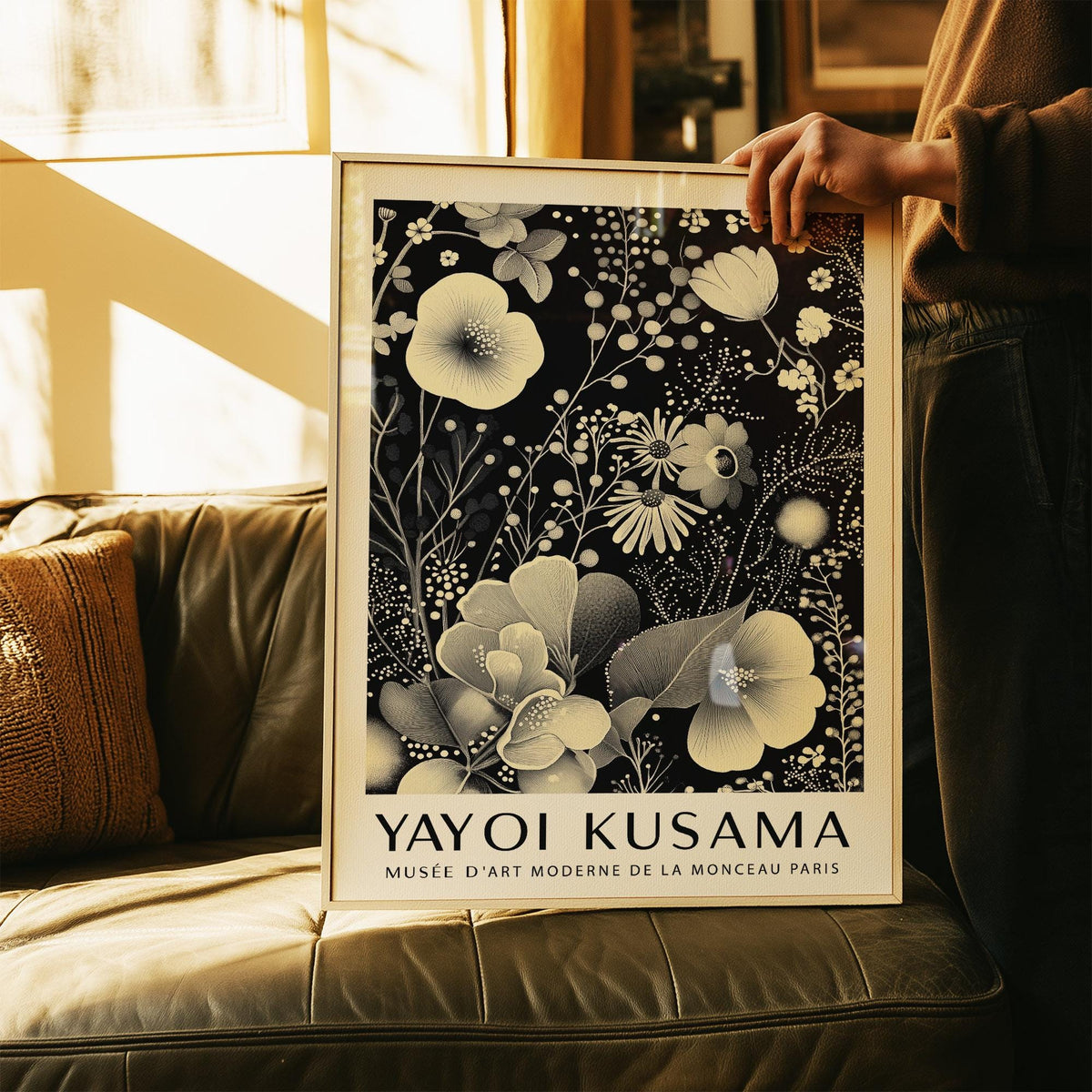 Large Floral Wall Art held in hands showing ivory floral pattern on black background with text below