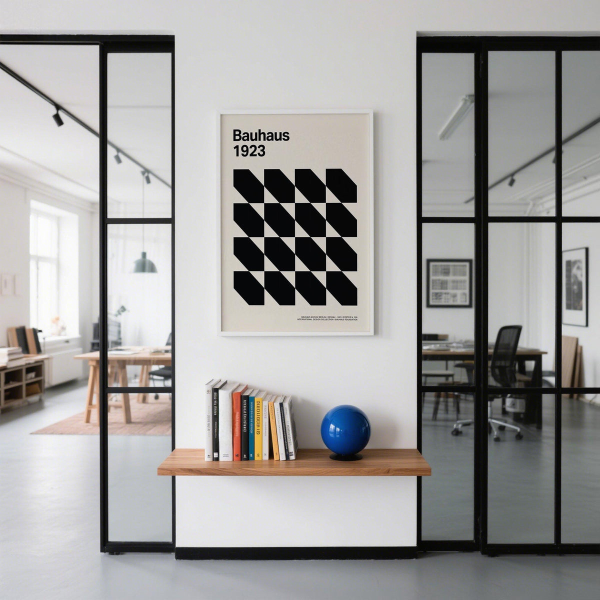 Corporate Office Artwork of black geometric grid shapes in a minimalist style on a white wall above a wooden shelf with a blue sphere