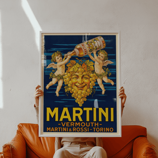Framed close-up of Vintage Vermouth Poster showing grape face with cherubs and vermouth bottle held above a brown leather chair