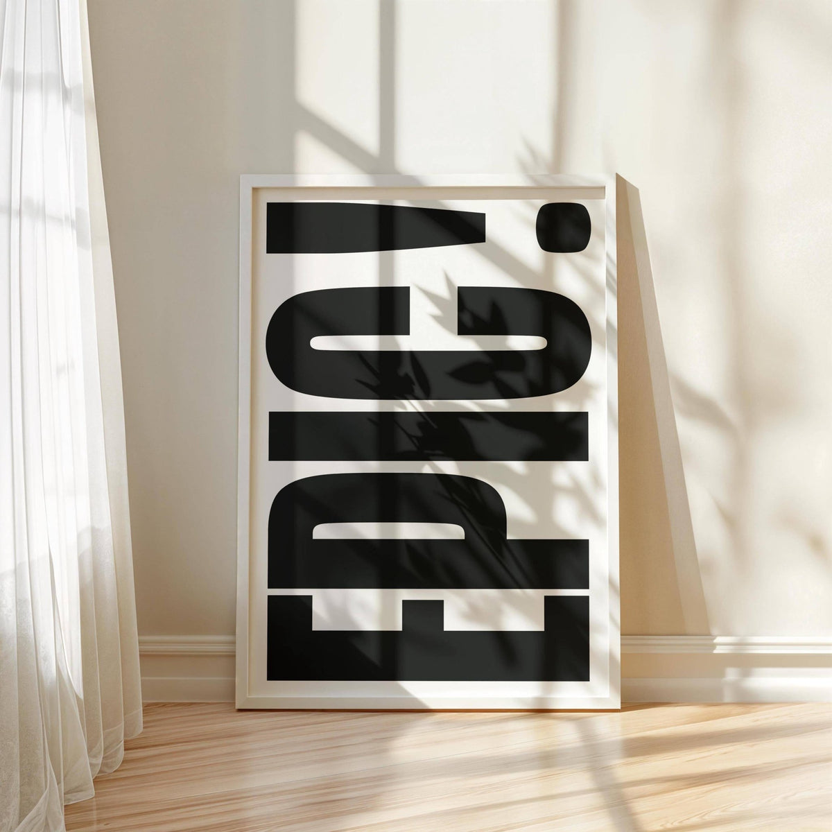 Big Text Sign wall art with black EPIC typography leaning against a wall with sunlight and shadow effects