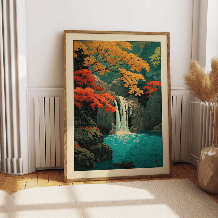 Hasui Kawase waterfall print leaning on floor by a vase with pampas grass in a bright room