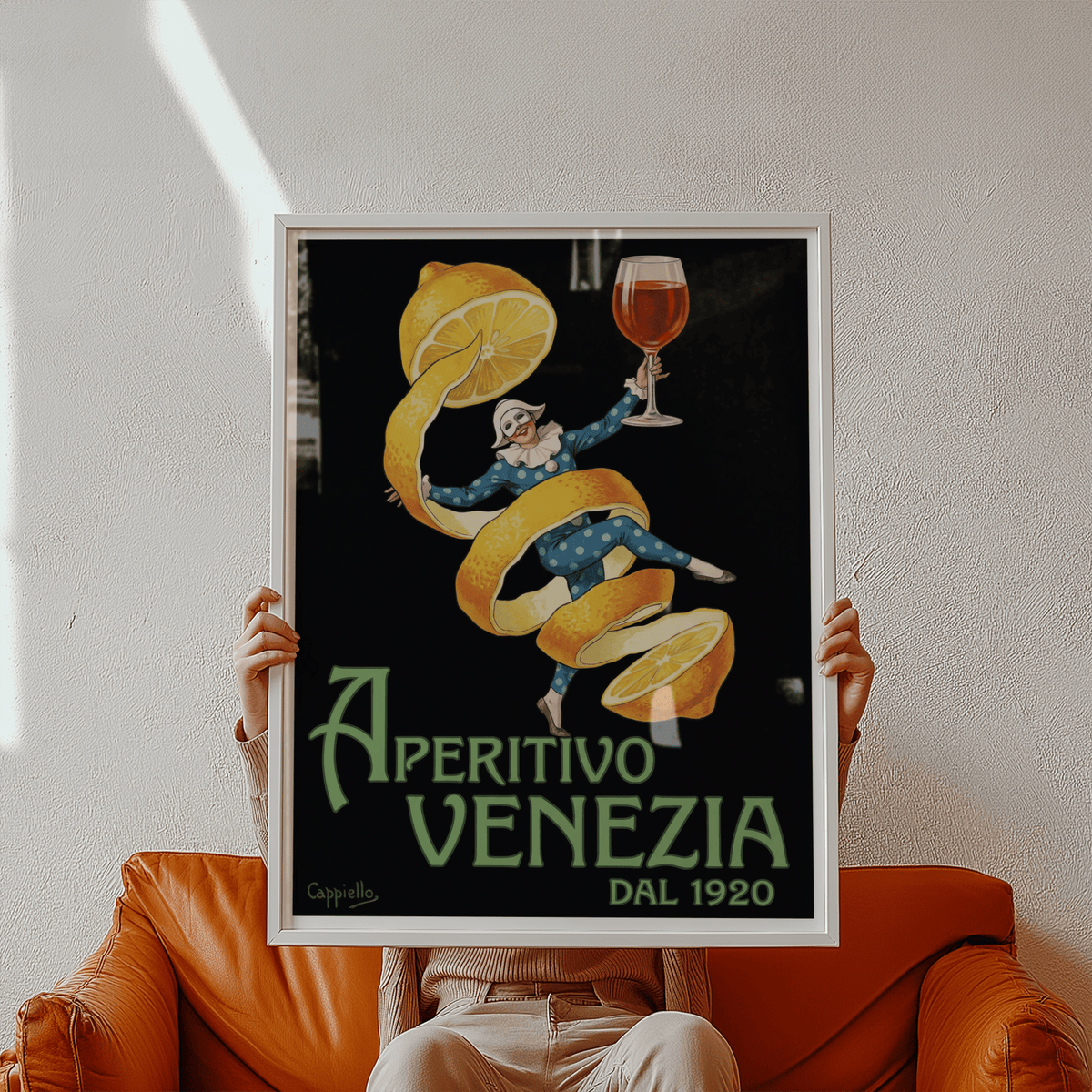 Framed Vintage Aperitivo Print of an apricot peel dancer holding a glass held above a brown leather sofa