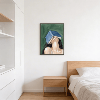 Woman Reading Portrait Print hanging above a wooden bedside table in a bedroom