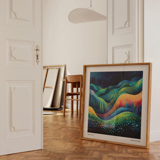 Scenic wall art leaning on the floor with bright abstract hills in a light room near a wooden chair
