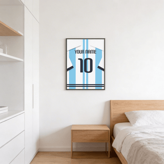 Football Shirt Poster in Light Blue and White Stripes hanging above a bedside table in a minimalist bedroom