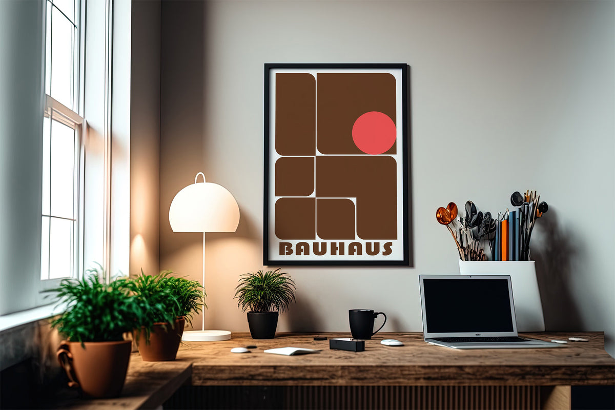 Wall art for offices with brown geometric shapes and a red circle above a desk with plants and a lamp