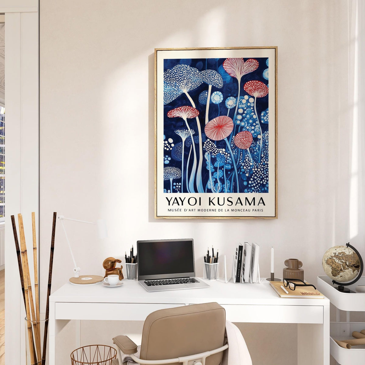 Mushroom art print with blue and red abstract mushroom shapes above a white desk in a home office