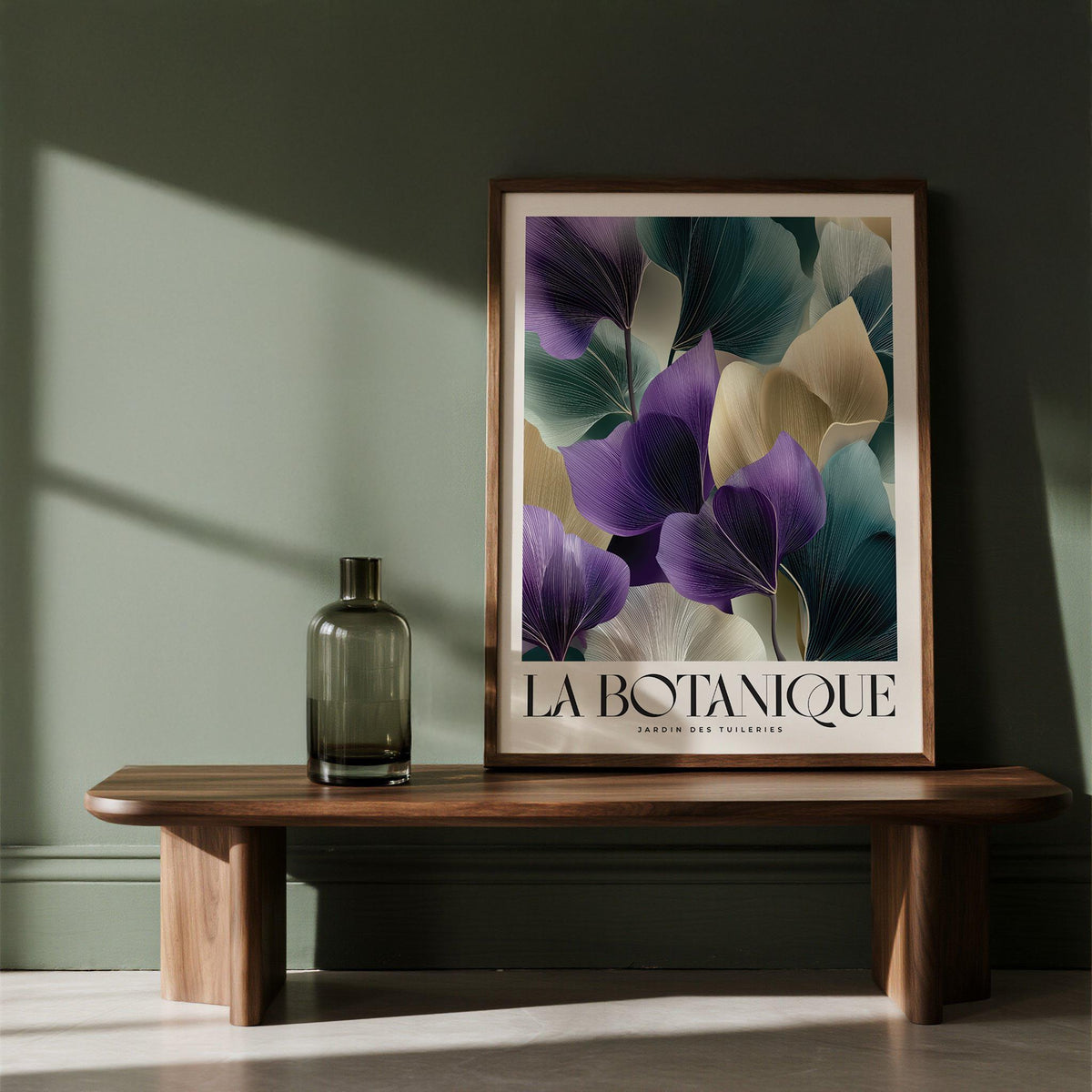 Framed Leaf Art Prints of abstract botanical leaves in purple and beige tones on a wooden shelf with a bottle