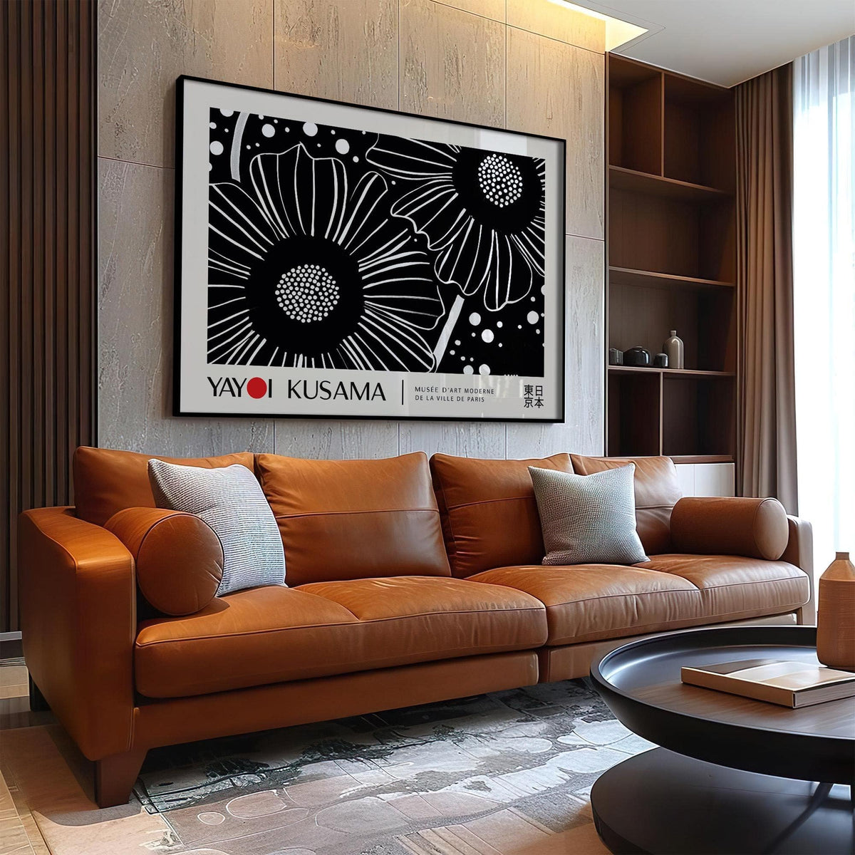 Horizontal wall hanging of black and white flowers in a minimalist style above a brown leather sofa