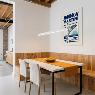 Vodka Martini Poster on a white wall above a dining table with an orange runner and fruit bowl