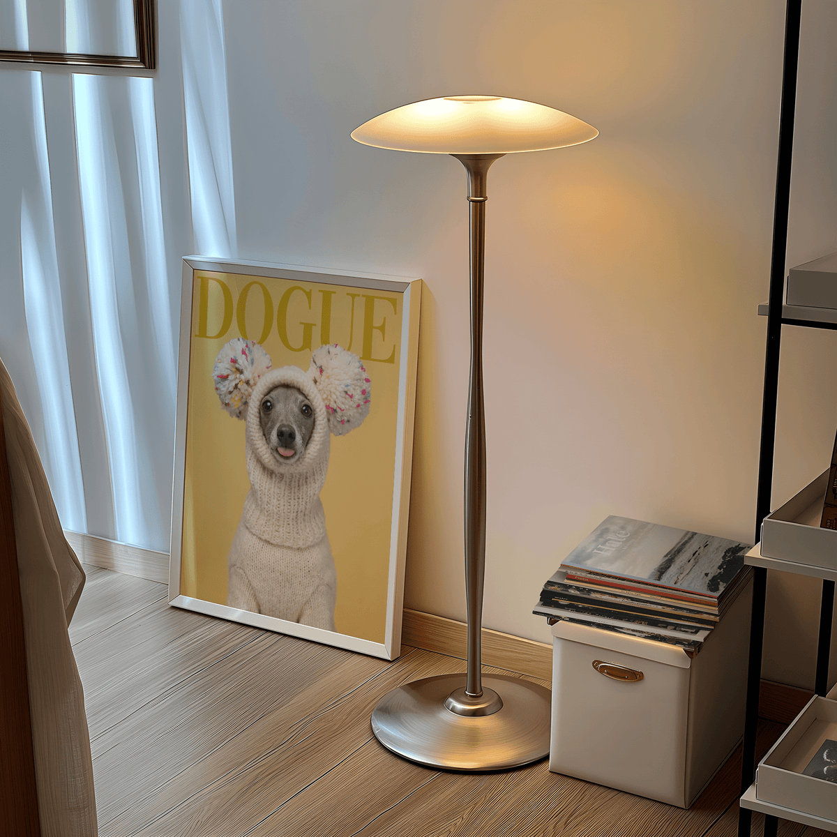Print leaning on floor featuring a greyhound in cream knit hat with pom poms near a floor lamp