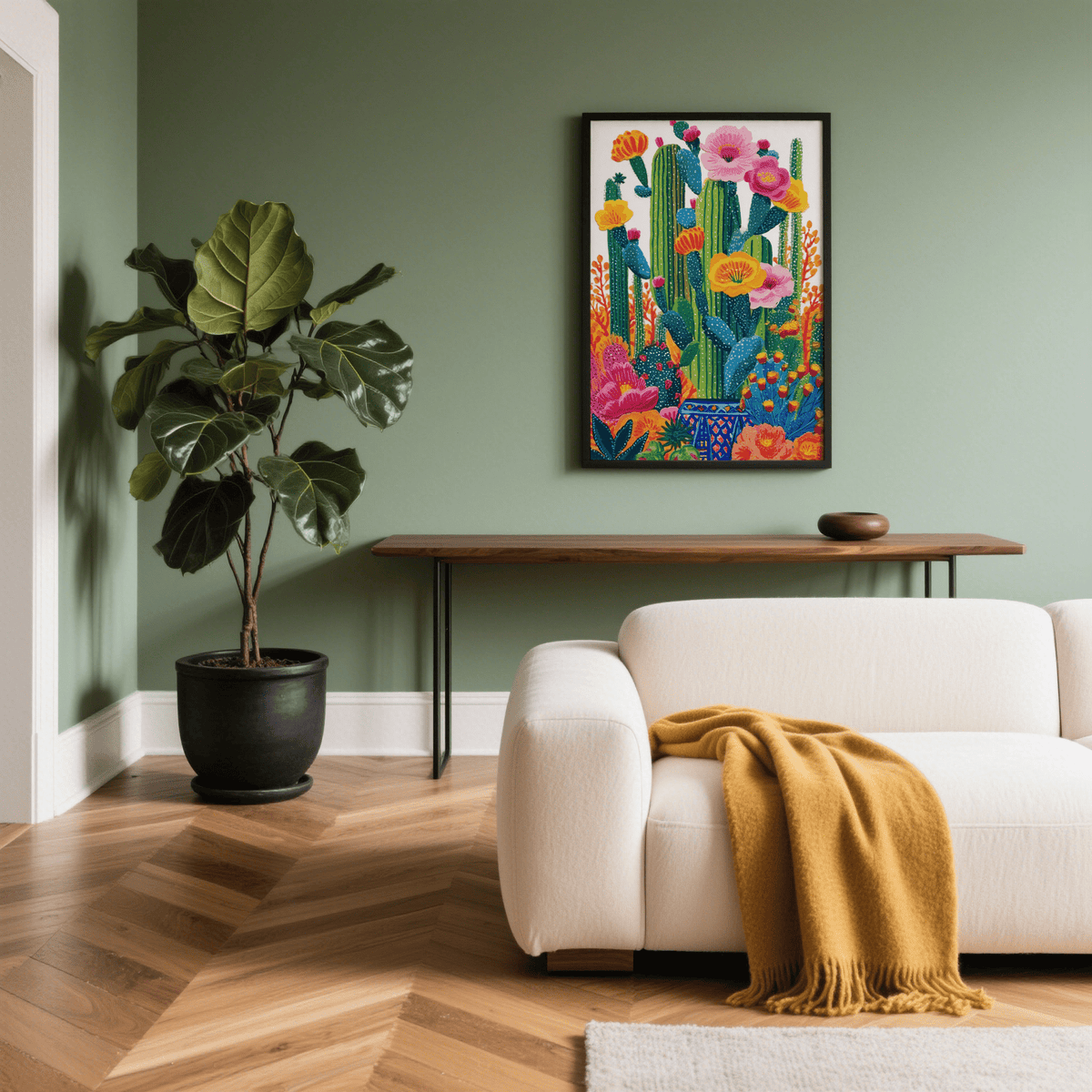 Cactus floral wall art in a black frame with colourful cactus and flowers above a wooden table and near a green plant
