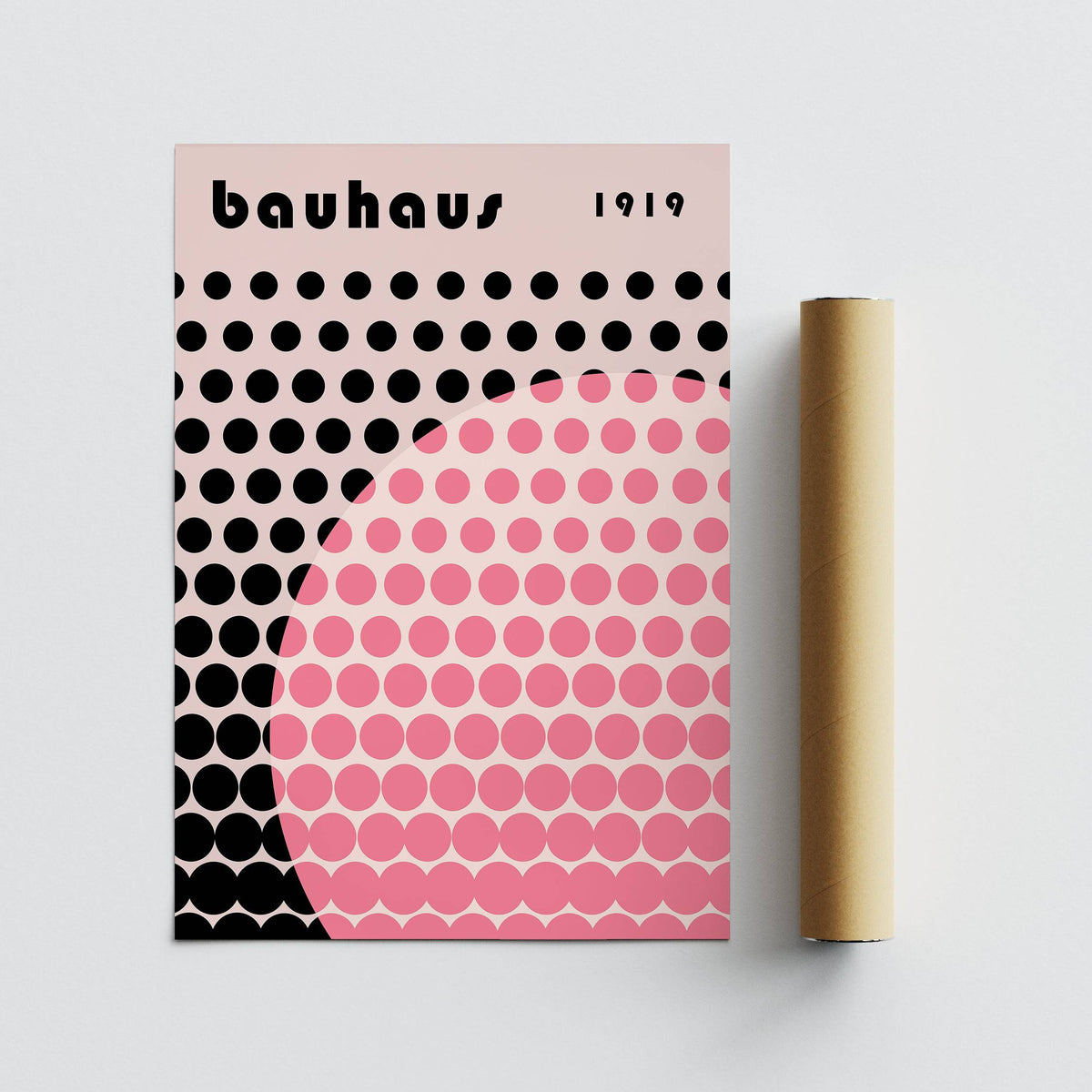 Bauhaus print poster rolled with packaging tube showing pink and black dots on pale background