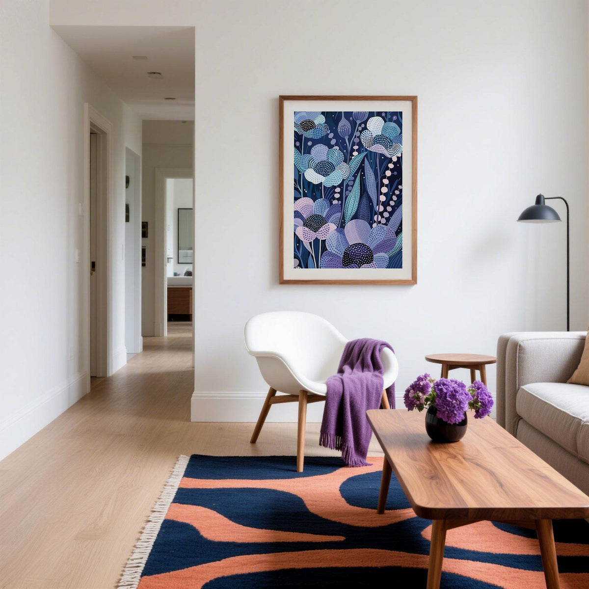 Modern Flower Art framed print with indigo floral pattern and pink accents in a living room with armchair