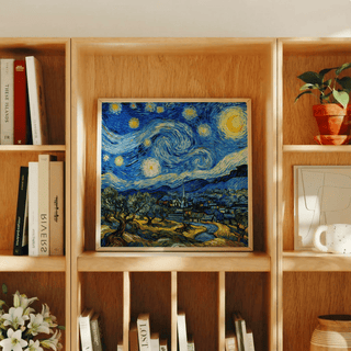 Starry Night Art Print leaning on a wooden shelf with books and a plant nearby