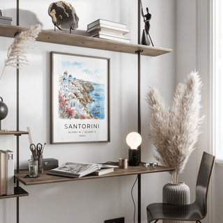 Santorini Art Print on wall above desk with plants and books in a bright room