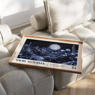 Moon Art Wall print of glowing mushrooms with blue tones laid on a beige sofa