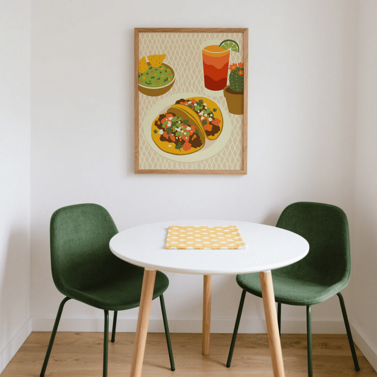 Tacos Art Print above a round white table with two green chairs in a dining nook