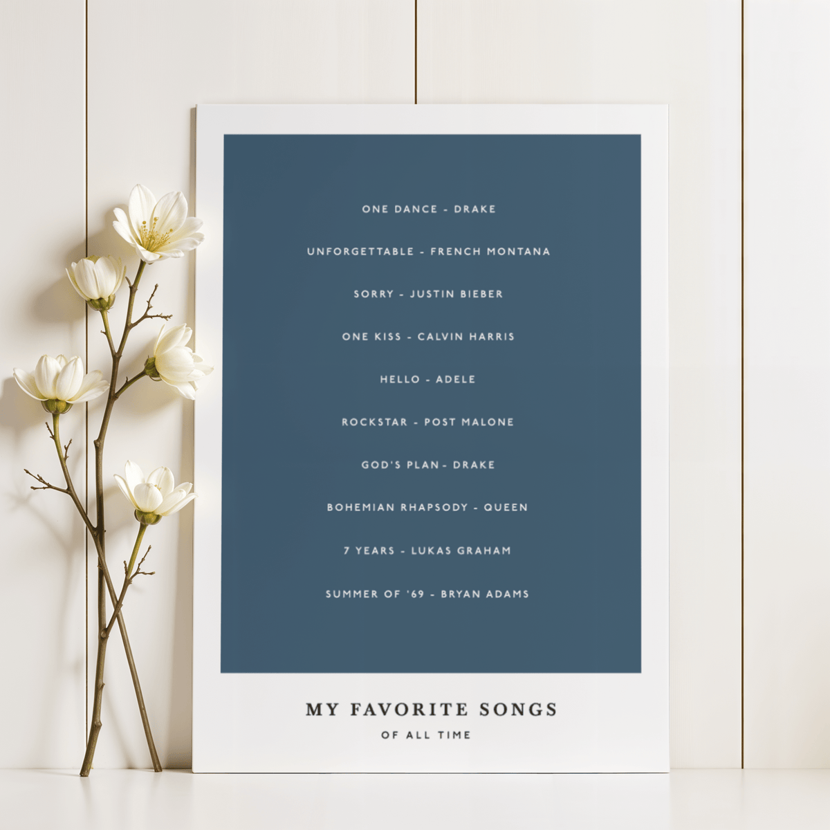 Custom Song Wall Art leaning against a cream panelled wall with white flowers on the side