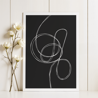 Modern black and white art of white fluid lines leaning on a white shelf next to white flowers