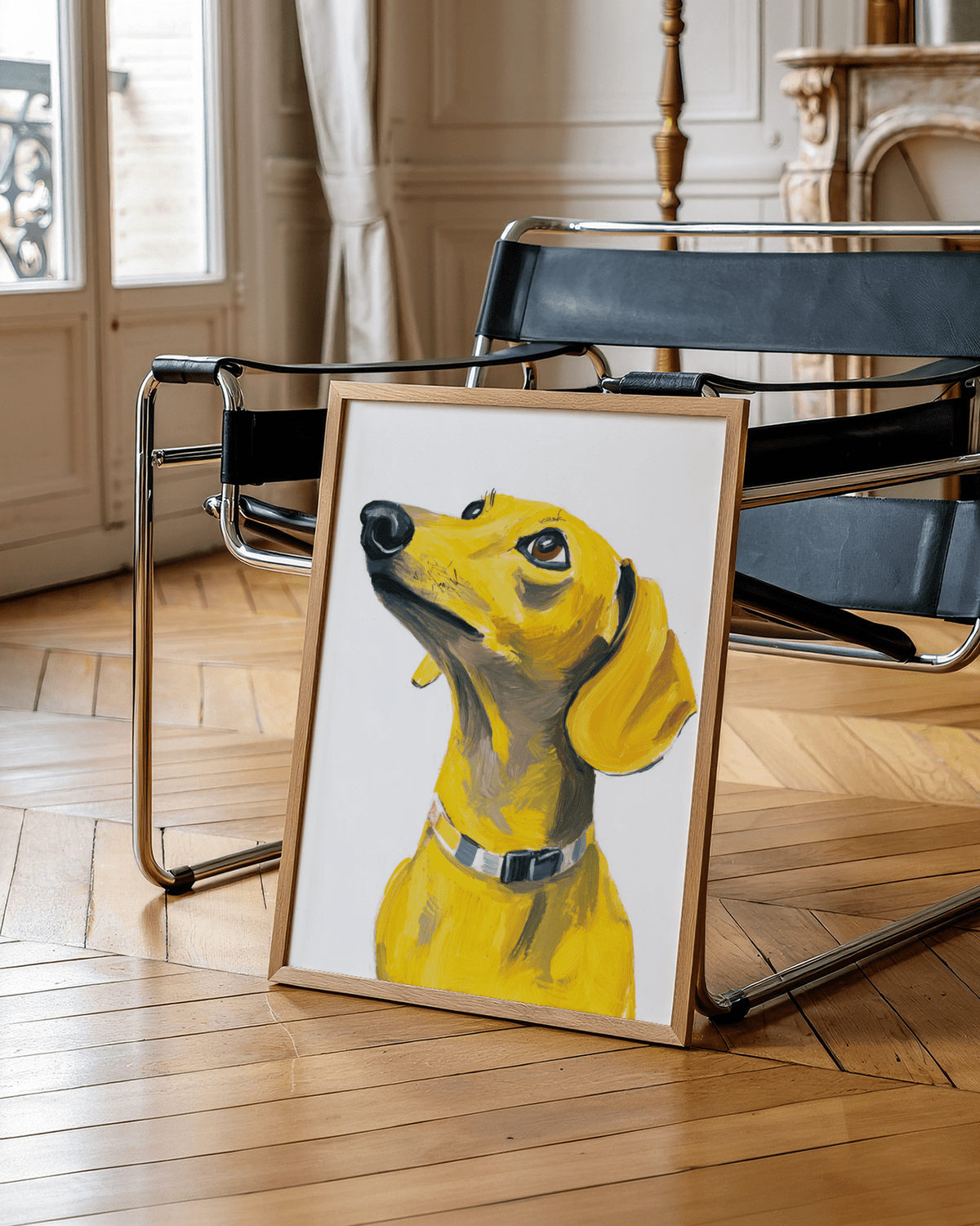 Print of a yellow dachshund dog leaning on a wooden floor in front of a black leather chair
