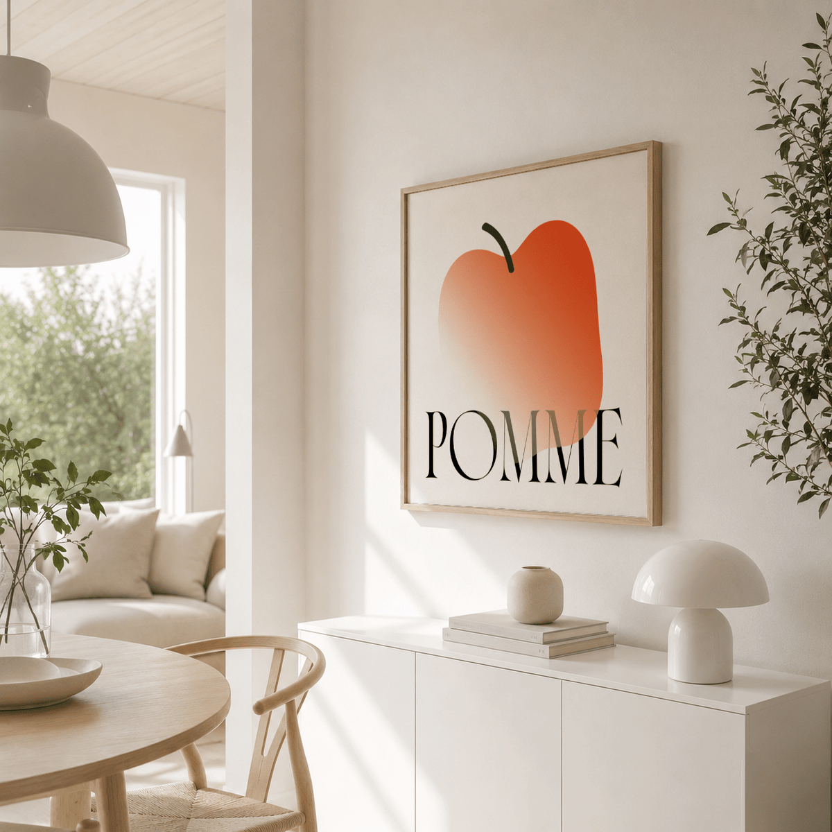 Minimalist Apple Art Print on wall showing abstract orange apple with black text above sideboard with lamp