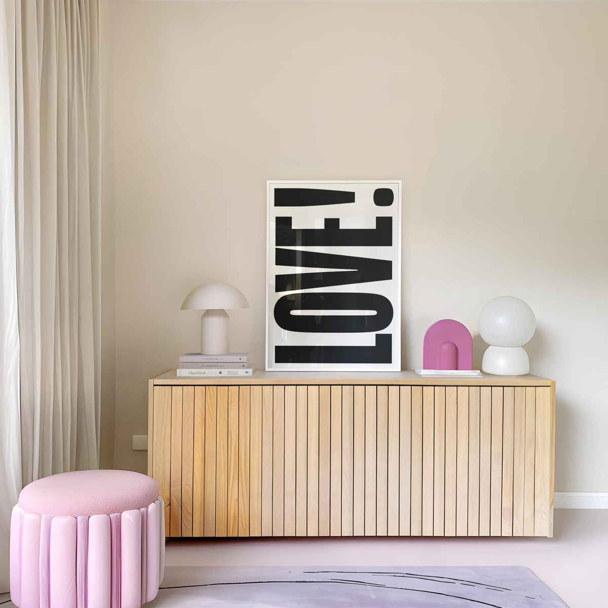 Large Motivational Posters leaning love typography in black and white on wood sideboard with soft furnishings