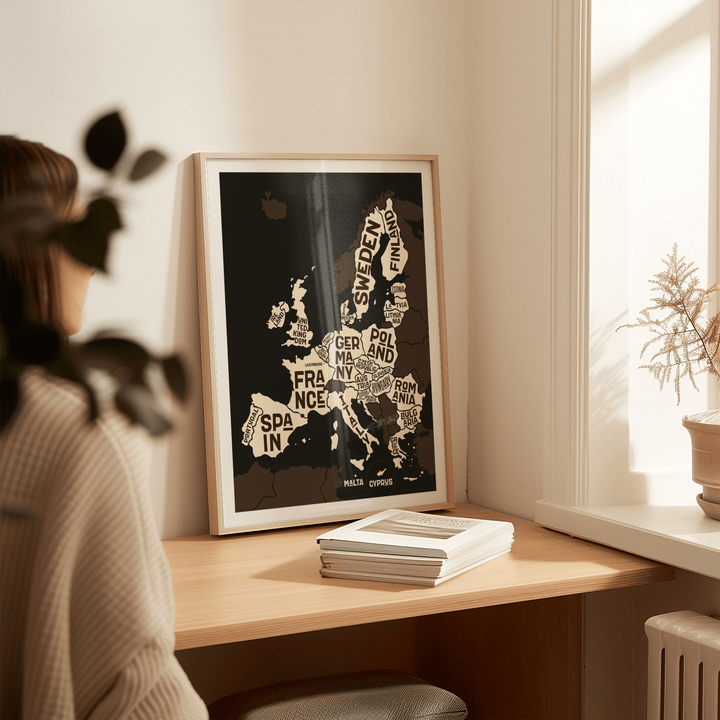 Europe Poster print leaning on a desk in sunlight with a plant pot nearby