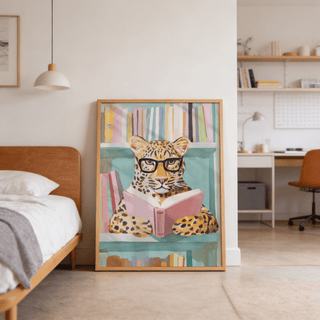 Reading Leopard Art Print leaning on the floor showing a colourful leopard with glasses holding a pink book in a bedroom