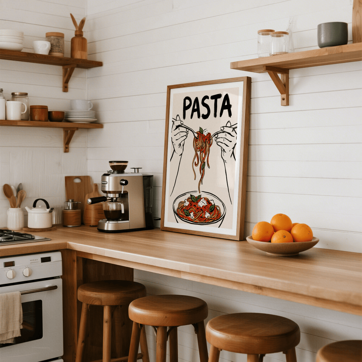 Pasta Art Print leaning on a kitchen counter with wooden stools and a bowl of oranges next to it