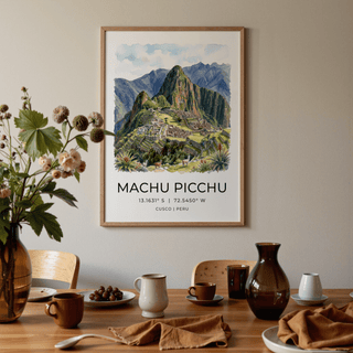 Print on a wall of Machu Picchu art print with green and brown watercolour details above a dinner table set