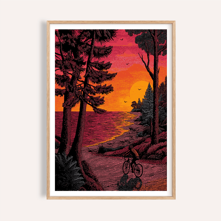 Framed Bicycle Adventure Print of a cyclist at sunset with pink and orange sky