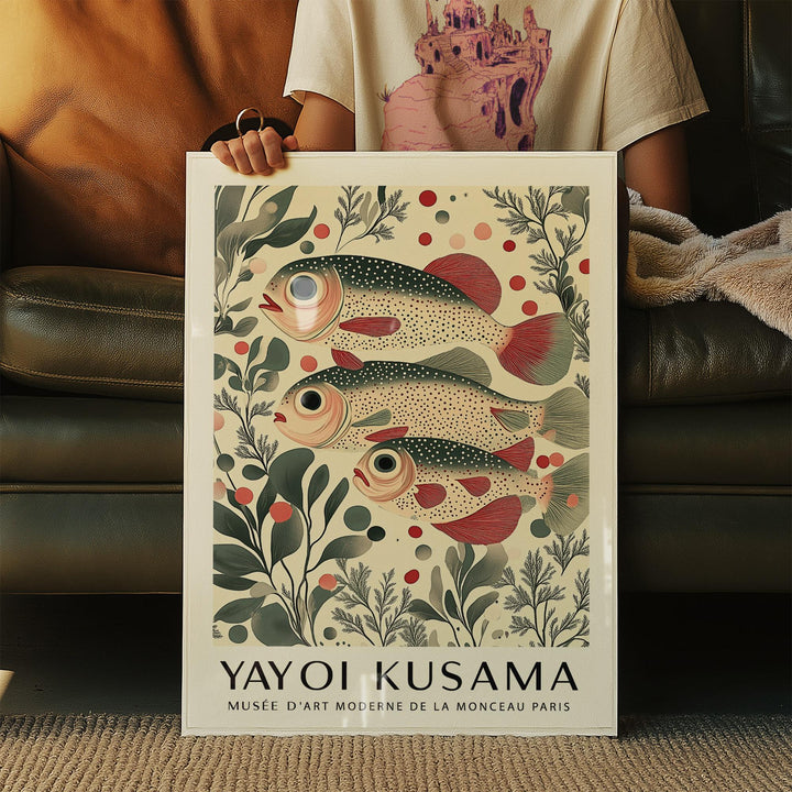 Framed wall art of fish showing a redfin trio with botanical illustration style held by person