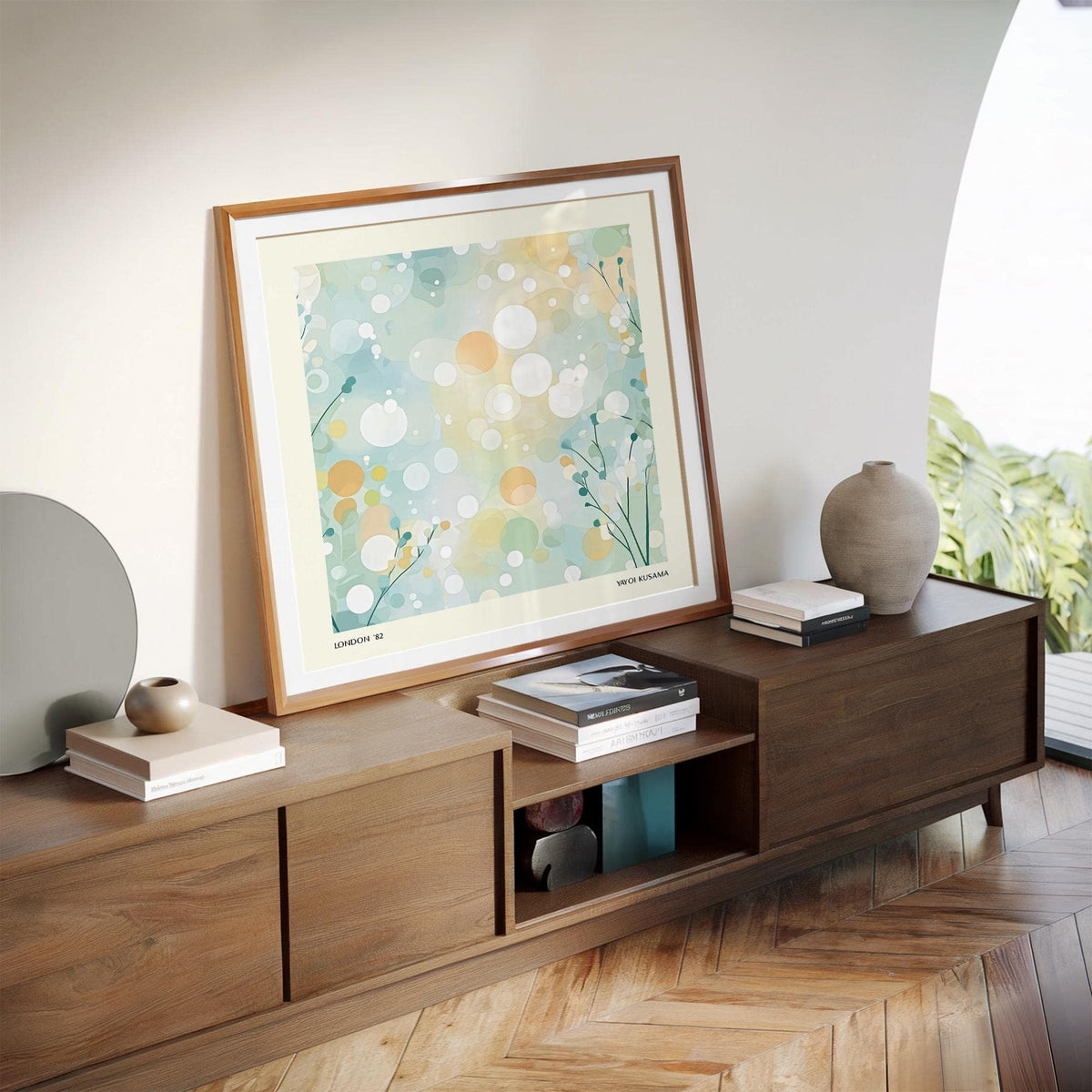 Sitting room wall art leaning on a wooden sideboard with abstract circles and dots in soft pastel hues