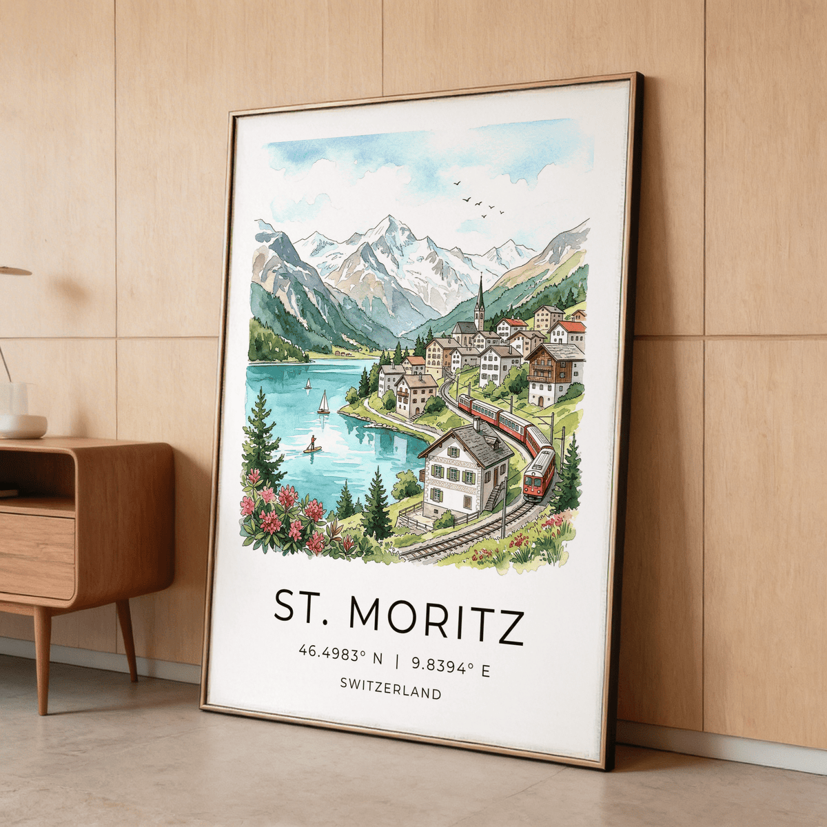 Swiss Landscape Art Print leaning on a wood-paneled wall near a small shelf with a cup and plant