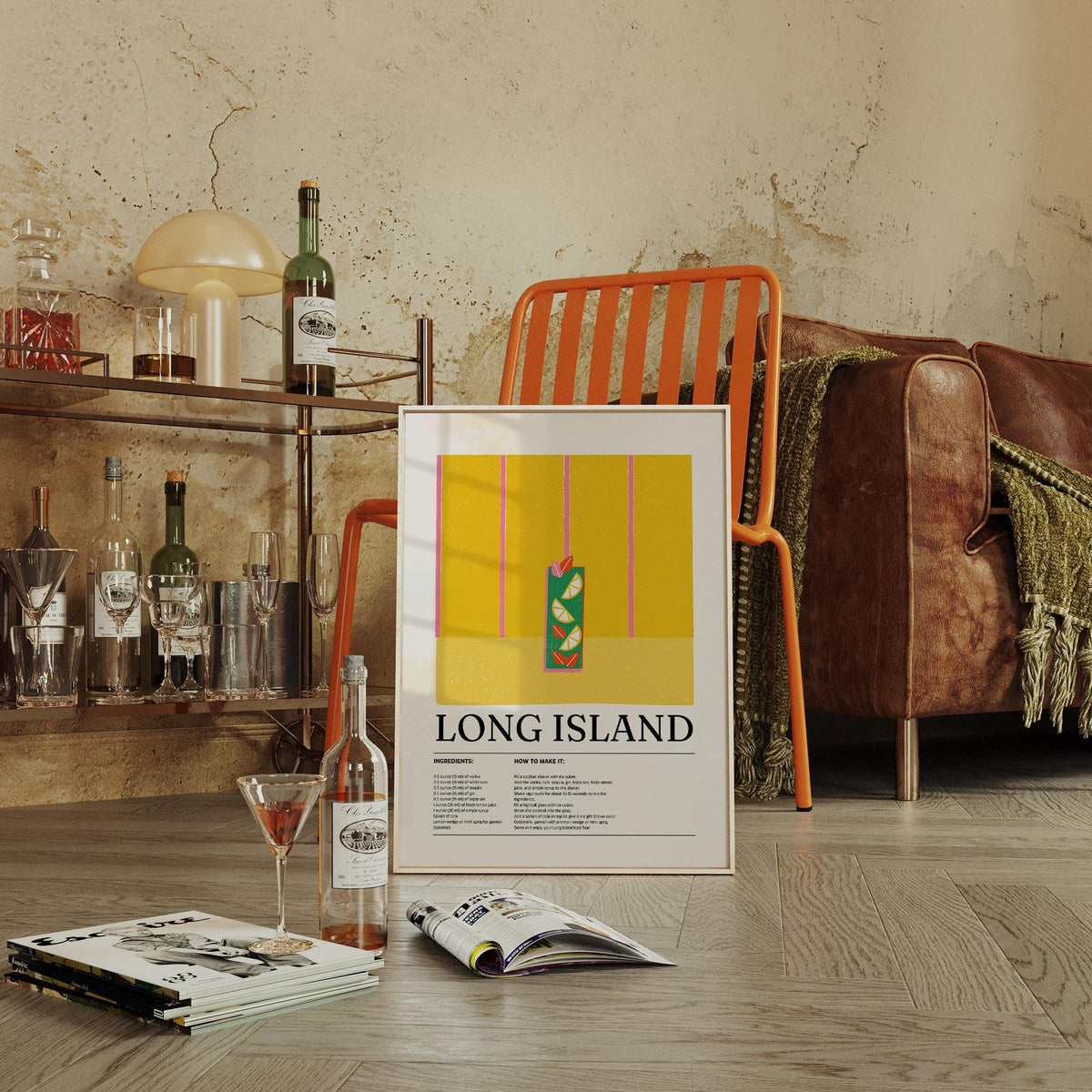 Drink print leaning on floor against orange chair with cocktail glass nearby in a cosy room