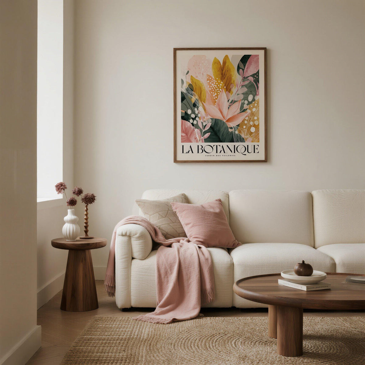 Flower Prints wall art of abstract botanical leaves in pink and green above a cream sofa with a pale pink throw