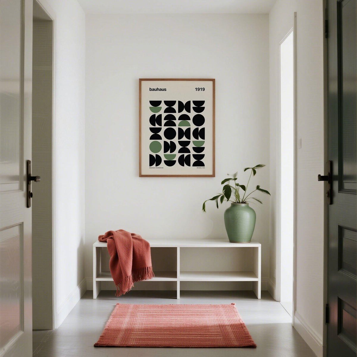 Gallery Print of geometric abstract shapes in black and green in a white hallway with a plant in a green vase