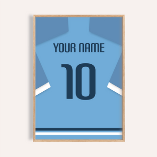 Framed close-up of a light blue football shirt with dark blue number 10 and custom name text