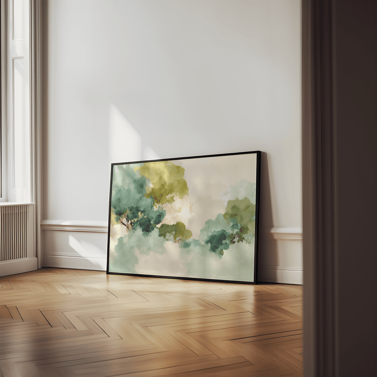 Print leaning on a floor of abstract clouds in green and blue tones with natural light on wall