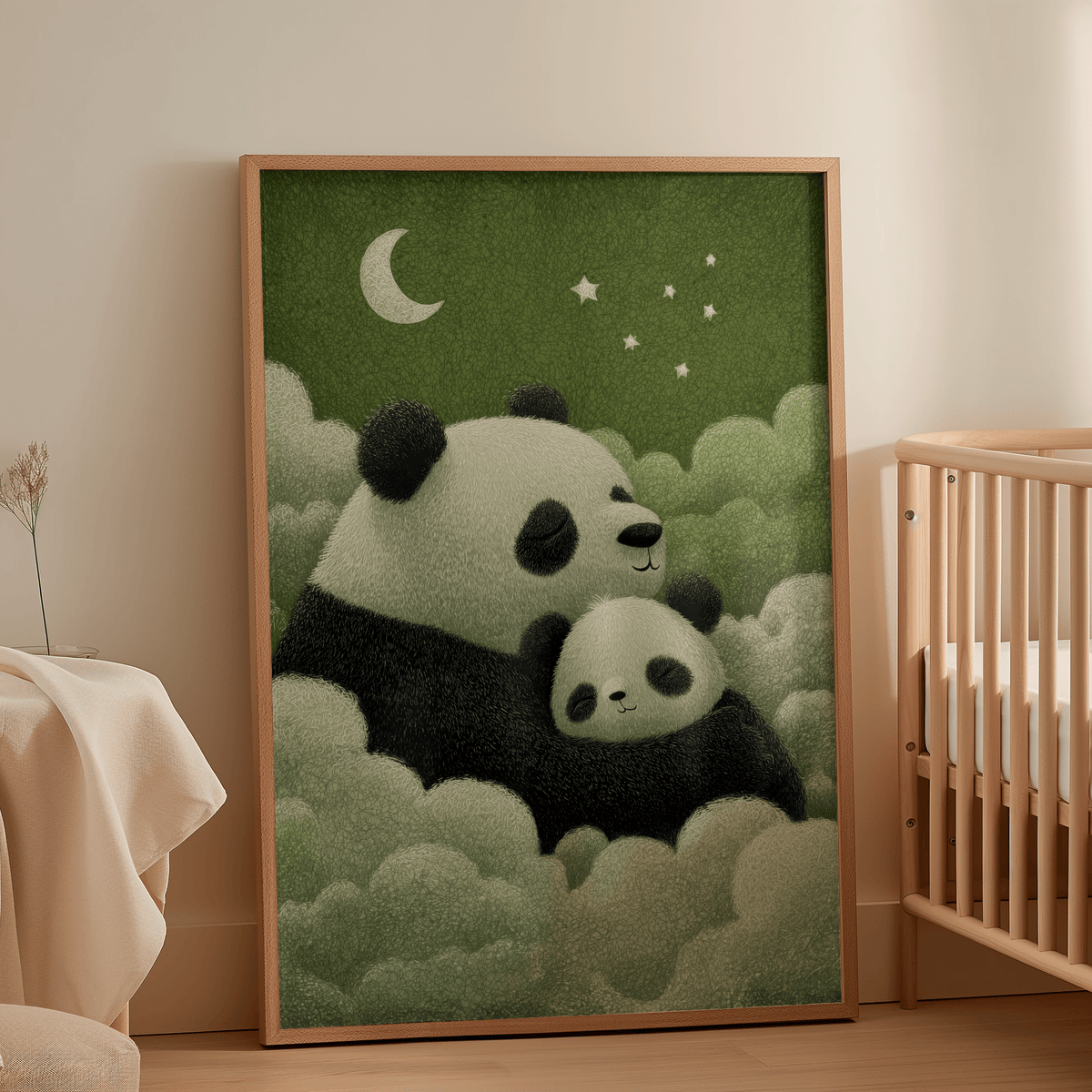 Print leaning on a floor next to a wooden cot shows sleeping pandas in green and cream tones in a nursery