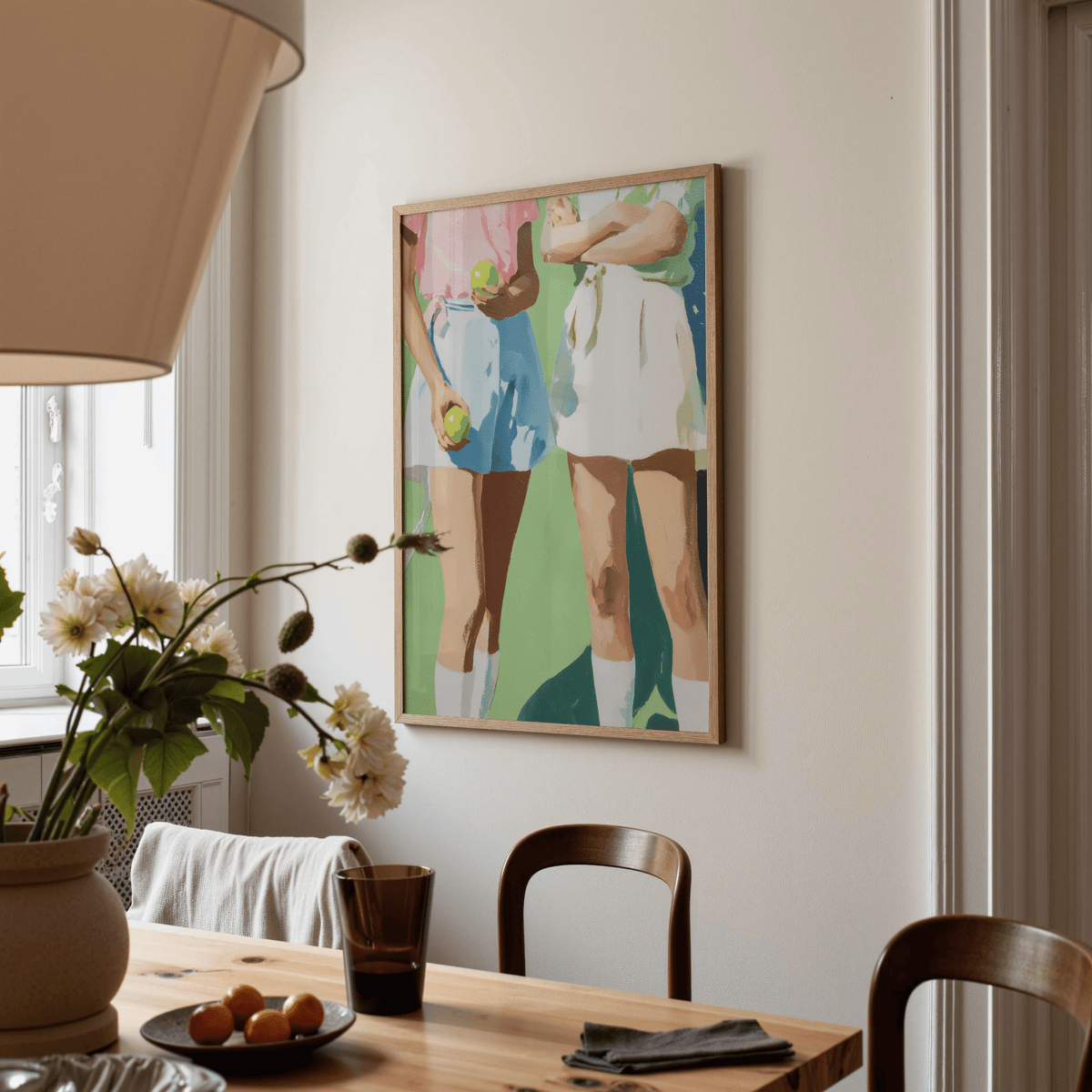 Tennis Girls Art Print on a neutral wall with green and blue tones in a dining room with a vase of flowers