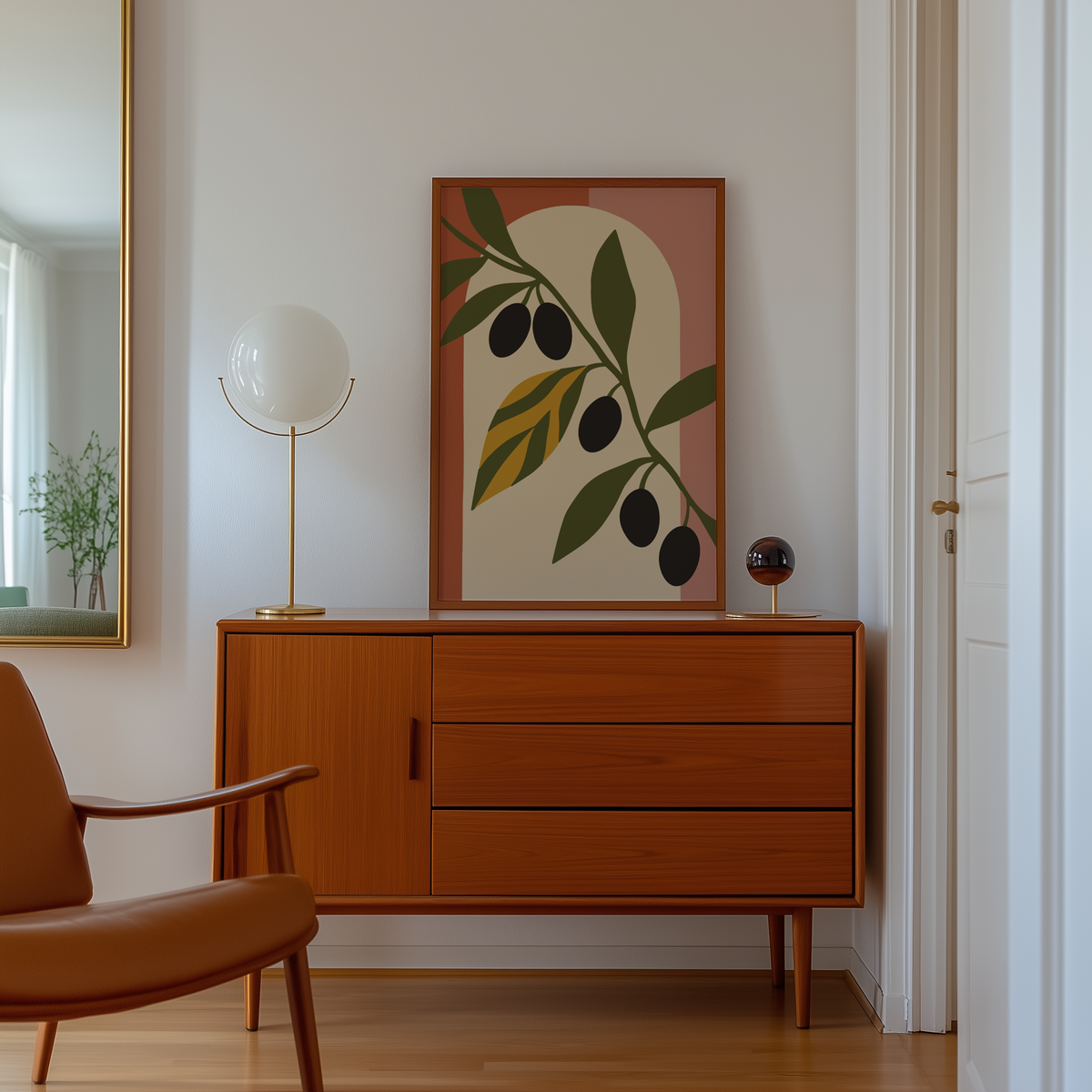 Cut paper olives on terracotta and pink above a mid century sideboard in a hallway