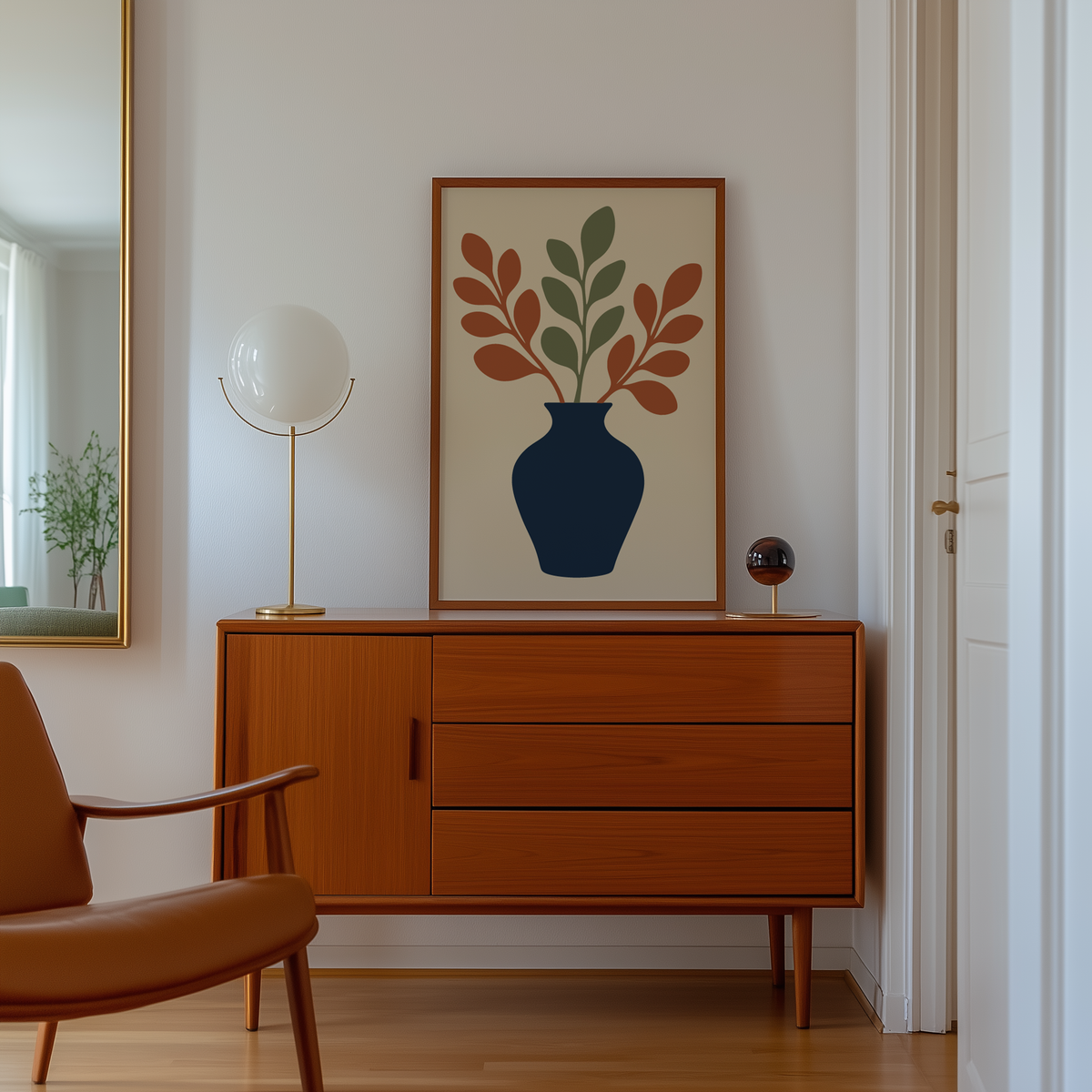 Cut paper vase and leaves print above a mid century sideboard in a hallway