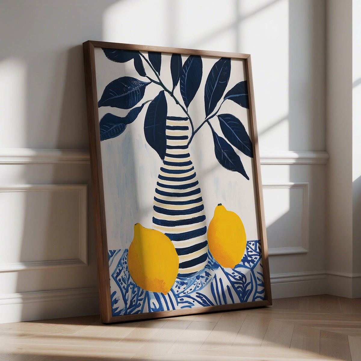 Framed Lemon Art Print with striped vase and bright yellow lemons leaning on a wooden floor
