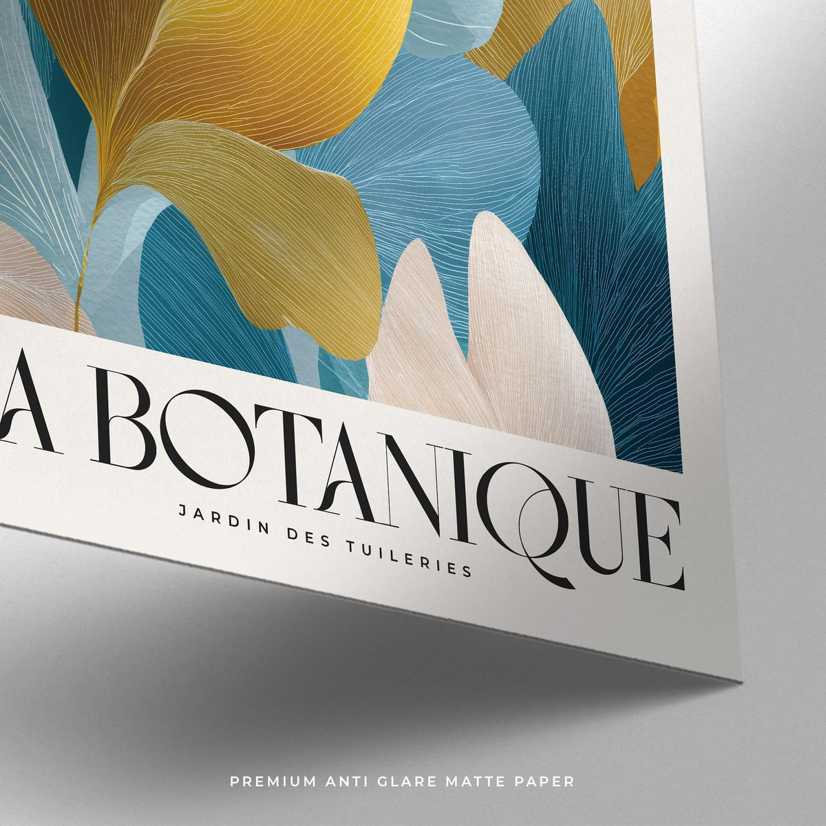 Detail close-up of blue and gold leaves with botanical illustration text on matte paper